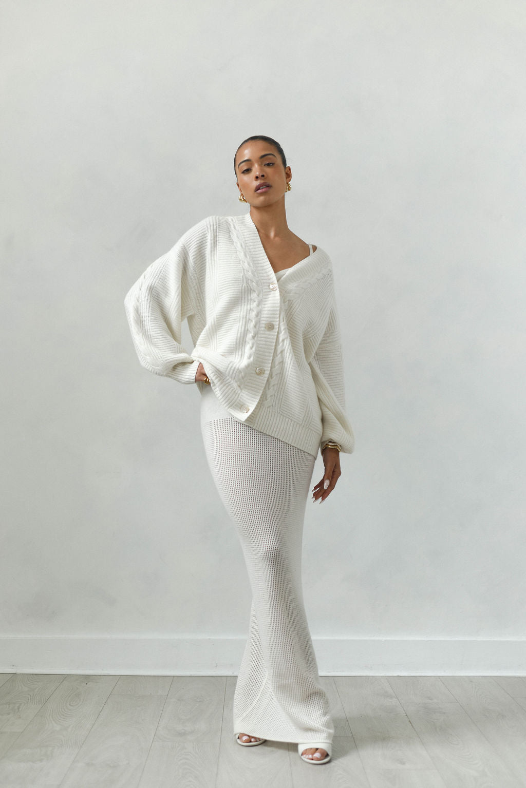 Person wearing a white outfit against a plain background