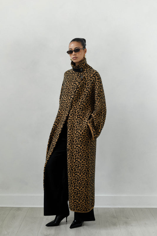 Person wearing a leopard print coat against a white background