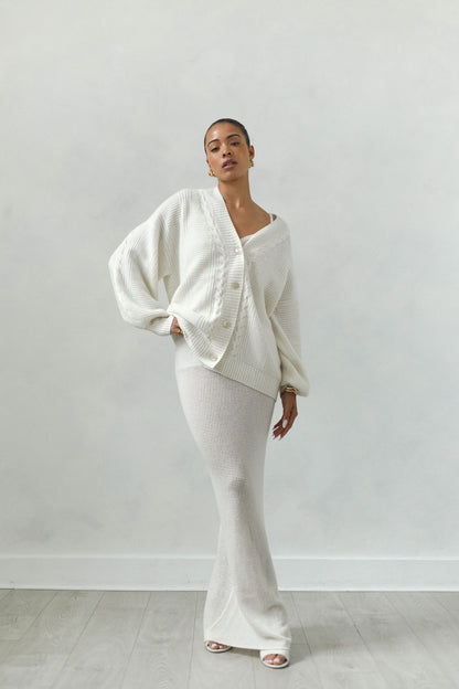 Person wearing a white outfit against a plain background